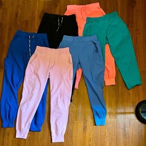 6 pair of Med Couture Insight size x-small jogger scrub pants.